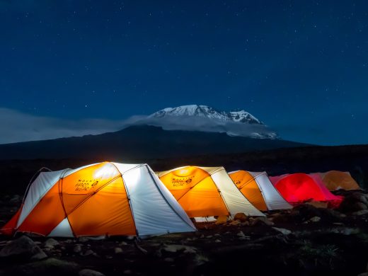 Orange,Tents,Illuminated,Before,Mount,Kilimanjaro,During,Night