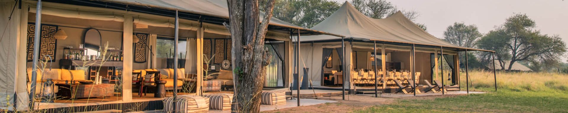 Luxury tented campsite in Serengeti National Park, Tanzania, with stunning views of the savannah and safari-style furnishings.
